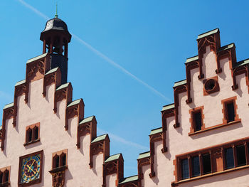 Low angle view of old building against blue sky