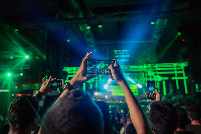 People enjoying music concert at night