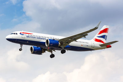 Low angle view of airplane flying against sky