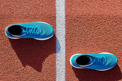 Blue running sneakers at stadium track