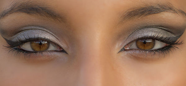 Close-up portrait of young woman with eye make-up