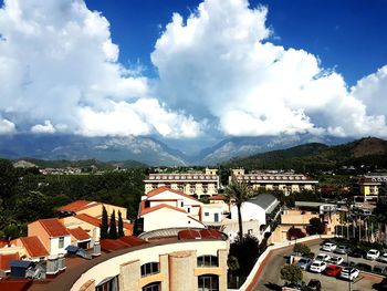 Buildings in town against cloudy sky