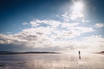 Man standing on beach against sky