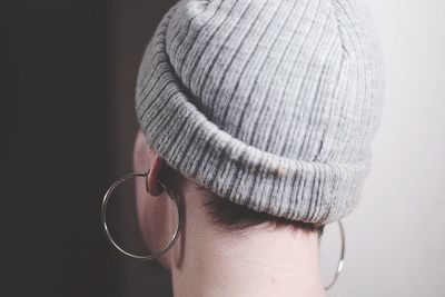 Close-up of woman wearing earrings and hat