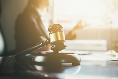 Close-up of gavel on table