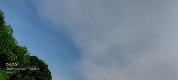 Low angle view of road sign against sky