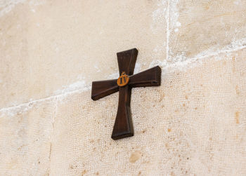 Close-up of cross sign on wall