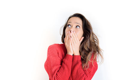 Portrait of young woman against white background