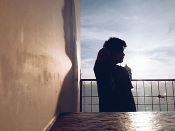 Man standing against sky in balcony