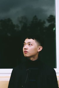 Portrait of young man looking away