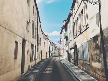 Empty alley amidst buildings in city