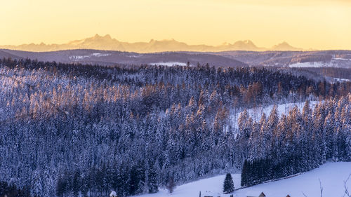 Scenic view of snowcapped mountains against sky during sunset