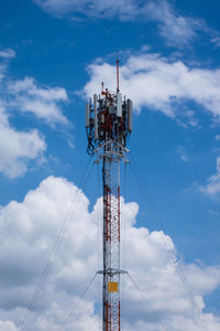 Low angle view of communications tower against blue sky