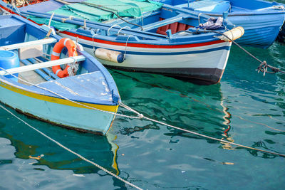 Close-up of boats moored in sea