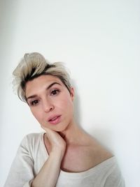 Portrait of beautiful young woman over white background