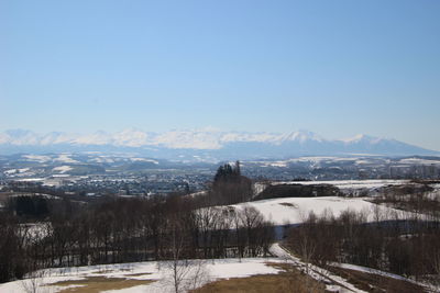 Scenic view of snowcapped mountains against clear sky