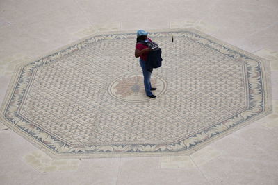 Full length rear view of woman walking on staircase