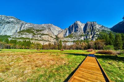 Scenic view of mountains against clear blue sky