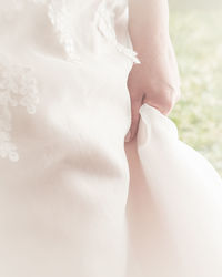 Close-up of hand holding white dress