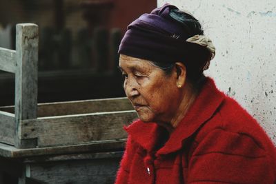 Worried mature woman sitting outdoors