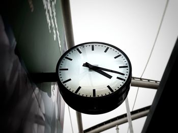 Low angle view of clock on wall