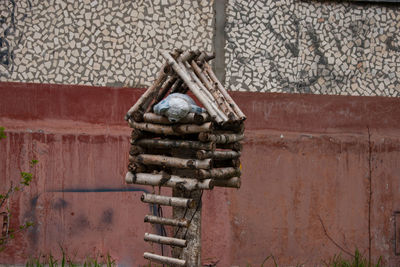 Stack of rusty metal against wall