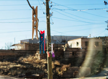 Close-up of clothespins hanging on cable