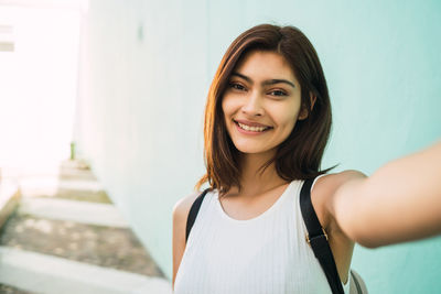 Portrait of smiling young woman standing outdoors