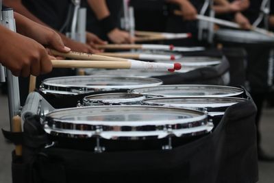 Cropped hands playing drums during celebration