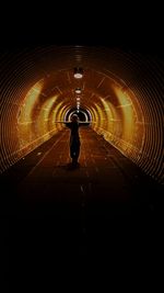 Man in illuminated tunnel