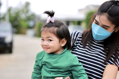 Portrait of mother and daughter outdoors