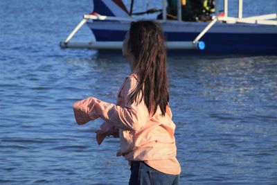 Rear view of woman standing in sea