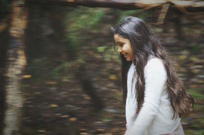 Happy girl walking in forest