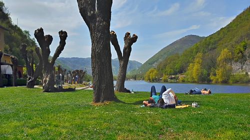 People sitting on grassy field