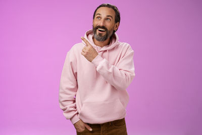 Excited man against purple background