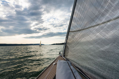 Close-up of boat sailing on sea against sky