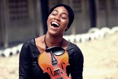 Smiling young woman with guitar