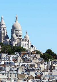 View of buildings in city against clear sky