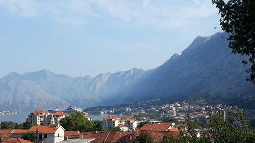 Town by mountains against sky