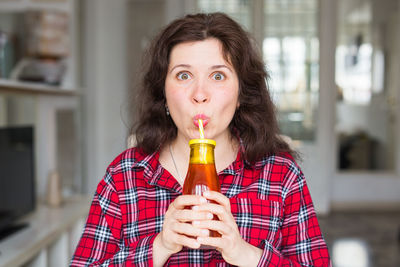 Portrait of smiling woman drinking drink