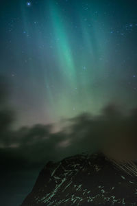 Scenic view of mountains against sky at night