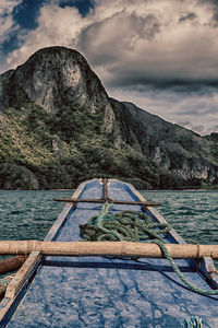 Scenic view of lake by mountains against sky