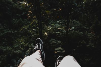 Low section of person relaxing on land