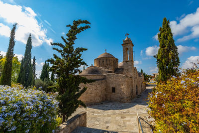 Panoramic view of trees and building against sky