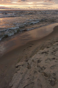 Scenic view of beach against sky during sunset