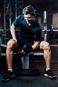 Low section of man exercising in gym