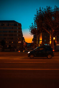 Cars on street in city at dusk