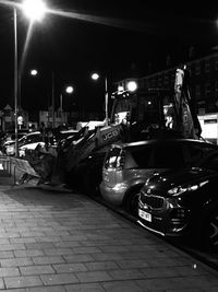 Cars parked on illuminated street in city at night