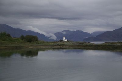 Scenic view of lake and mountains against sky