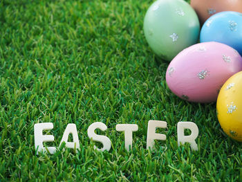 High angle view of multi colored eggs on grass